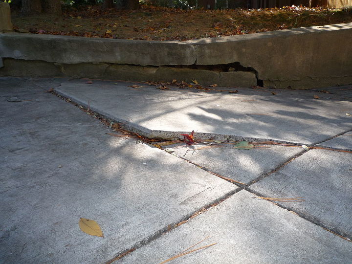 sink hole under driveway retaining wall