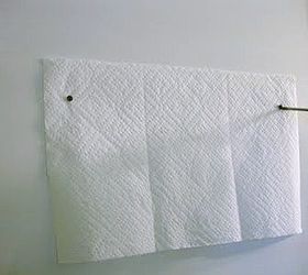 how to hang a wall object with two hooks, home maintenance repairs, Hold the paper towel in place with a piece of tape Then tighten the screws into the wall on the marks you created with the screwdriver