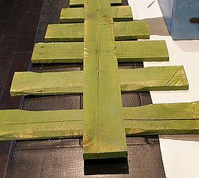 diy pallet christmas tree tutorial, christmas decorations, pallet, repurposing upcycling, seasonal holiday decor, After painting the boards lay the trunk down on the boards to get the spacing you want