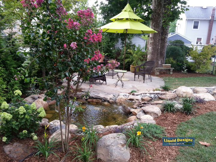 a tranquil meandering stream and koi pond grace this small backyard, landscape, ponds water features, Enjoy your meals that much more with a little touch of Nature now part of your outdoor living area