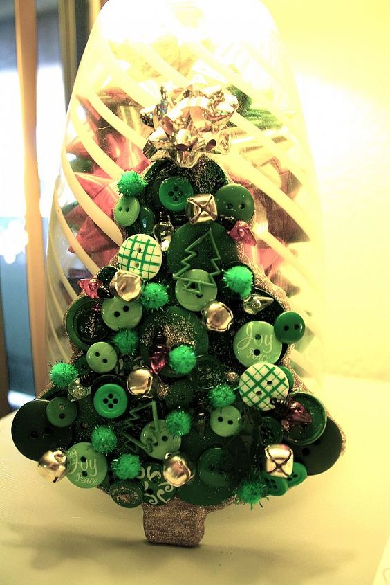 buttons glitter and bells diy christmas decorations, christmas decorations, crafts, seasonal holiday decor, wreaths, I made this from a cardboard cutout in the shape of a tree and just started sporadically glueing buttons of every shape and shade of green I owned