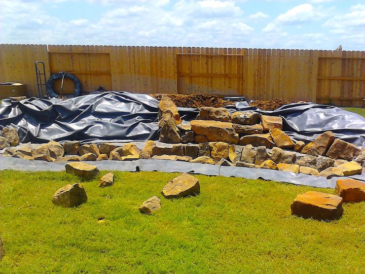 james wanted a twenty two foot wide waterfall in his sugarland texas backyard, landscape, outdoor living, ponds water features, Two Signature Series Skimmers have been installed and attached to the liner and the fun begins creating multiple beautiful waterfalls from the bottom up