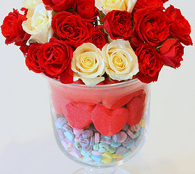 valentine s day centerpiece, seasonal holiday d cor, valentines day ideas, Place a tall and narrow drinking glass inside the large hurricane Fill the glass with roses and water Around the sides pour the sweet heart candies in the bottom Place two layers of red heart peeps around the hurricane on top of the candy voila A Valentine s Day treat