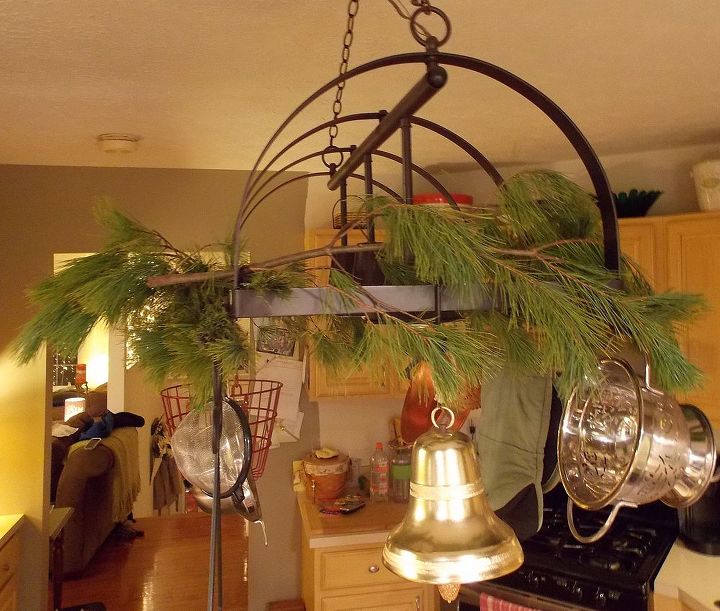 using fresh pine as holiday decor, seasonal holiday d cor, Drape branches across pot rack light fixture Use wire to attach if needed