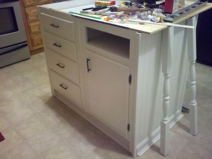 old base cabinets repurposed to kitchen island, I painted the legs and cabinets and attached new hardware