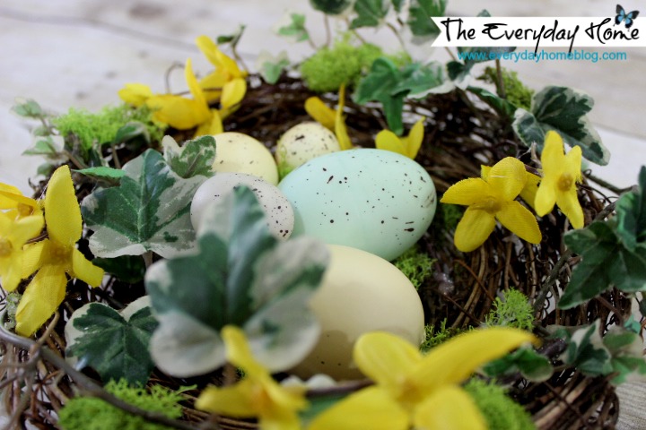 an easy spring bird nest with speckled eggs project, crafts, seasonal holiday decor, wreaths, Bits of ivy forsythia and moss decorate this pre made grapevine nest