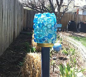 diy garden art, crafts, gardening, And then screwed the jar onto the lid Not only does it shimmer in the sunlight it gives off a soft blue glistening glow at night thanks to the solar light inside Should the light quit working I can simple untwist it and replace the battery in the light