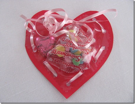 heart treats, crafts, seasonal holiday decor, I bought some pink plastic on a roll at Joann s Fabrics cut out hearts from it and some red cardstock paper and punched holes around the edges and laced them together with a bow at the top
