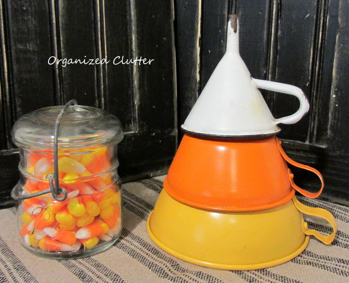 re purposing funnels as candy corn, crafts, repurposing upcycling, seasonal holiday decor, Display with the handles showing or without