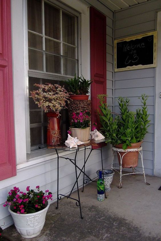 perked up porch, outdoor living, porches, A thrift store table for 3 00 was used to hold additional plants