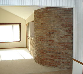 help can you help redo this living room rock brick bookshelf off center window, Right side of living room shows same window curved brick wall and planter