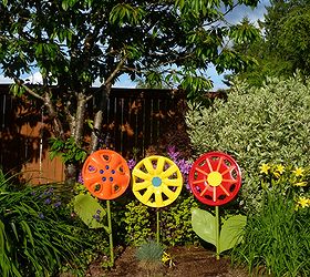 hubcap flower yard art, crafts, flowers, gardening, painting, Use broken shovel handles as stems and enjoy the flowers as yard art