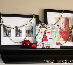 gift wrapped photo gallery wall, seasonal holiday decor, wall decor, Draping colorful strands of beads is a fun way to bring some festive flare to the display without covering up all of your photos