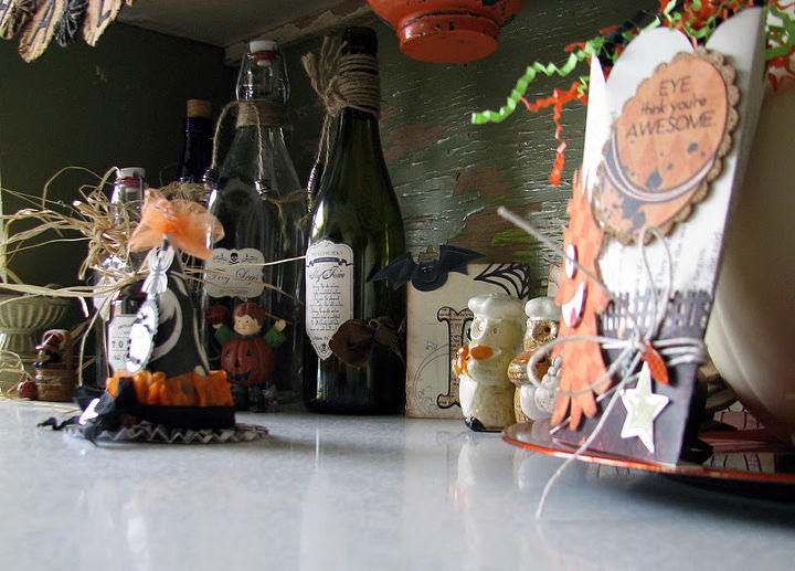 frugal fall decorating, crafts, flowers, repurposing upcycling, seasonal holiday decor, Recycled bottles that I added spooky labels to