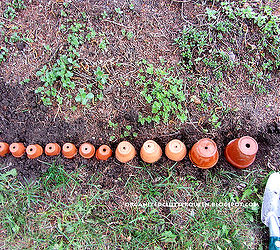 making a terra cotta pot flower bed edging, flowers, gardening, perennials, I line up my pots upside down to make sure I have enough pots for the edging After I have the correct line up I dig the pots down into the dirt about 2 inches