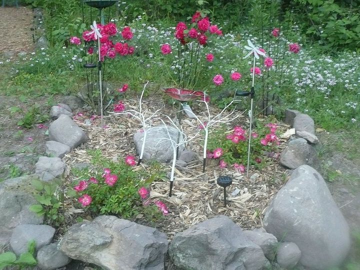 whimsical garden ideas, gardening, This is our small rose garden The three trees in the center fiber optic and change colors The rocks are dusted in glitter but it does not show in this photo