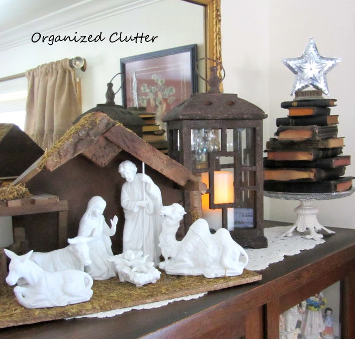 a nativity set a stacked bible christmas tree, christmas decorations, repurposing upcycling, seasonal holiday decor, A china cabinet top First Christmas vignette
