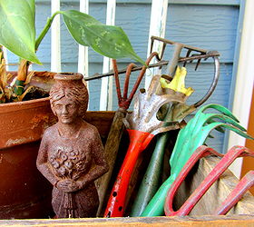 covered patio outdoor vignettes, home decor, outdoor living, repurposing upcycling, Vintage garden hand tools a peace lily and a rusty iron lady figurine