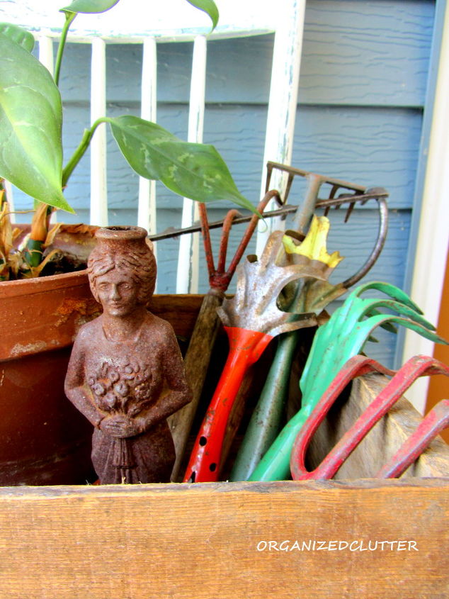 covered patio outdoor vignettes, home decor, outdoor living, repurposing upcycling, Vintage garden hand tools a peace lily and a rusty iron lady figurine