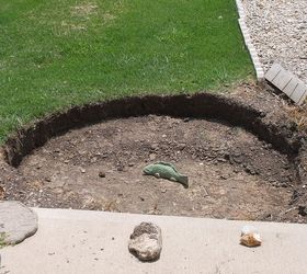 our new pond, outdoor living, ponds water features, Finally the hold was dry enough to dig on again I just had to sit the concrete fish in the hole for a couple days Company got a laugh at it