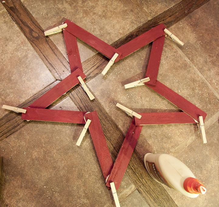 how to make stars from left over wooden shims, crafts, woodworking projects, Now start playing and rearranging until you have the general shape This takes some doing especially if you don t use clothespins like I do For the large star you ll need ten shims and five for the smaller one