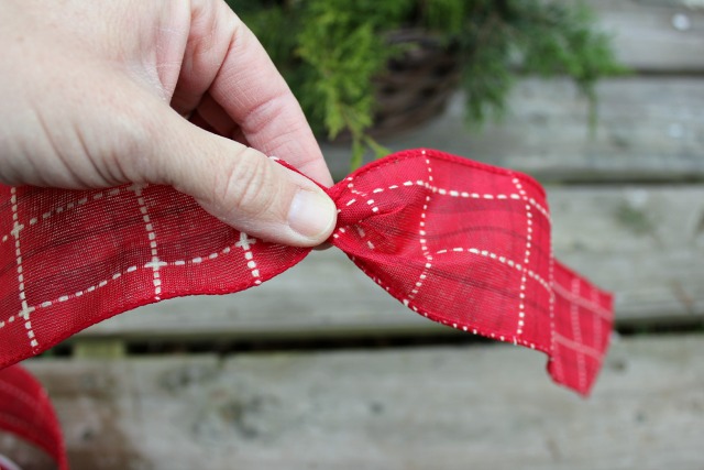 how to make a bow for a christmas tree, christmas decorations, crafts, seasonal holiday decor, Using wired ribbon twist a few inches from the end Depending on how long you want the tails of your bow to be