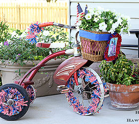 are you decorating your bike for the fourth of july, christmas decorations, flowers, gardening, patriotic decor ideas, repurposing upcycling, seasonal holiday d cor, Here is Trixie The Tricycle all decked out for the Fourth I used a Hobby Lobby garland to weave through the wheels