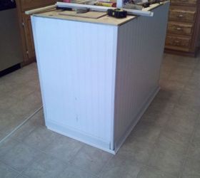 old base cabinets repurposed to kitchen island, I added beadboard and trim