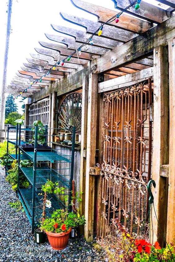 falling for a garden gone wild with amazing reclaimed features, flowers, gardening, outdoor living, repurposing upcycling, these amazing eclectic panels that face the front Wouldn t a fence done in this treatment be outstanding