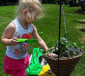 toddler herb garden, gardening, outdoor living, The height of the planter on the garden flag stake is perfect for a toddler to get her hands dirty