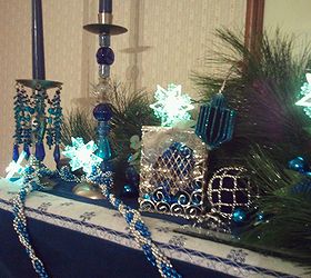 chanukah mantelpiece designs, christmas decorations, seasonal holiday d cor, Beaded garland tinsel dreidels colored glass balls in the tzedakah charity box 6 sided lighted snowflakes like the Jewish star available at Big Lots and a repurposed ornament with winter greens as a backdrop
