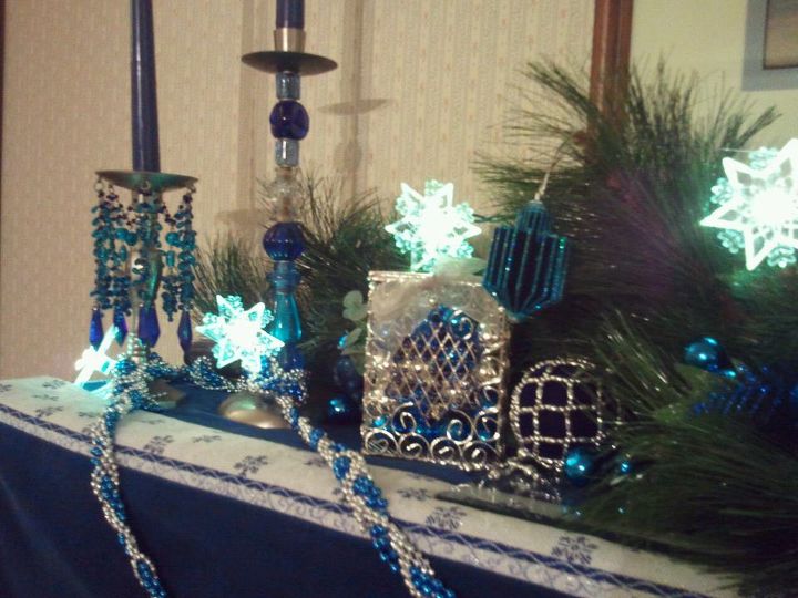 chanukah mantelpiece designs, christmas decorations, seasonal holiday d cor, Beaded garland tinsel dreidels colored glass balls in the tzedakah charity box 6 sided lighted snowflakes like the Jewish star available at Big Lots and a repurposed ornament with winter greens as a backdrop