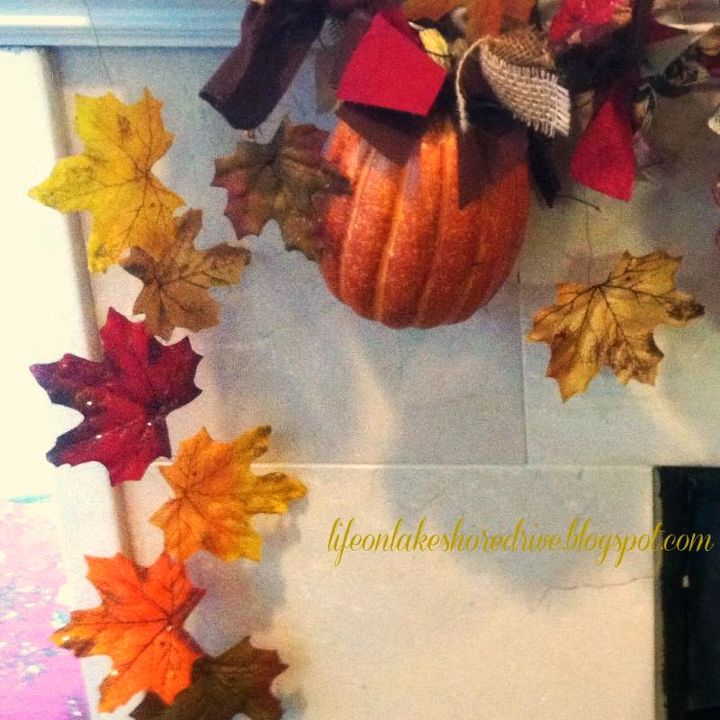 fall mantel garland using pine cones pumpkins leaves and fabric, crafts, fireplaces mantels, repurposing upcycling, seasonal holiday decor, I pushed floral wire through the leaves to give them a floating appearance