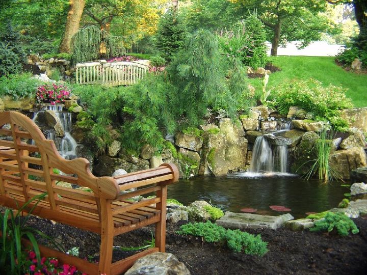 can retaining walls be beautiful as well as functional, gardening, landscape, outdoor living, ponds water features, pool designs, Backyard Stream and Waterfall Bill Renter used moss rock boulders to support his front yard s two waterfalls one close to new bench the other at the end of 85 foot stream