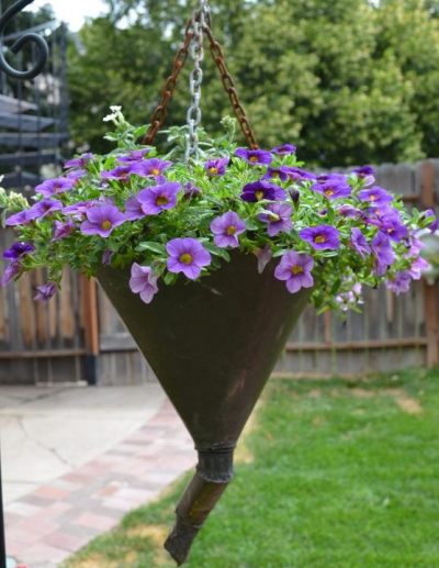 how to make garden containers from old funnels, container gardening, crafts, gardening, repurposing upcycling, To make Marie recommends drilling three evenly spaced holes at the top edge of funnel using a 1 8 bit Insert three small S hooks Cut metal chain into three equal lengths with metal snips Attach chain pieces to the funnel using