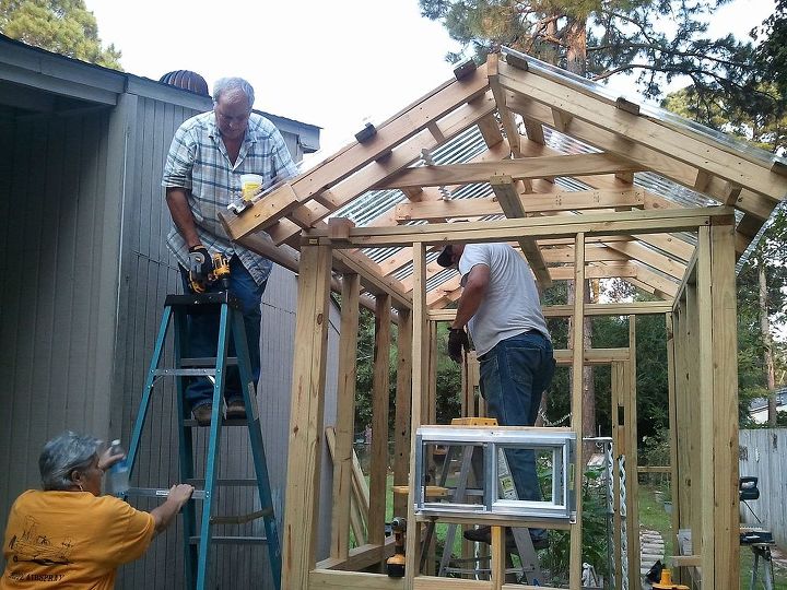 greenhouse built for less than 700, diy, gardening, outdoor living, Sun tuf panels going up for the roof Sure was glad to have family that doesn t mind helping out