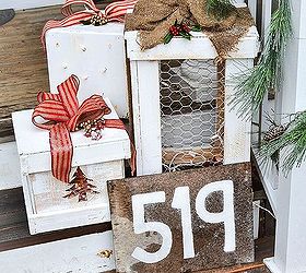 make pretty light up wooden presents for your porch, lighting, porches, seasonal holiday decor, During the day they are a bright white with colorful ribbon embellished with faux and real holly berries