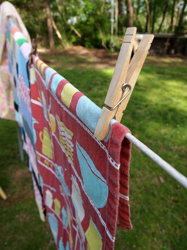 how to host a successful yard sale, Hang fabric items on the line so customers can see what they re buying